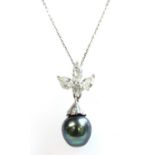 A white gold diamond and cultured pearl pendant and earrings suite,