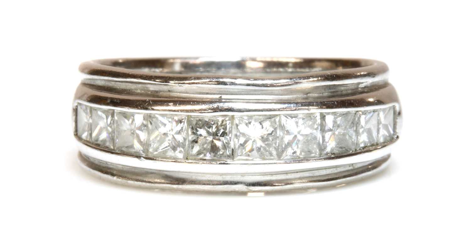 An 18ct white gold diamond half eternity ring,