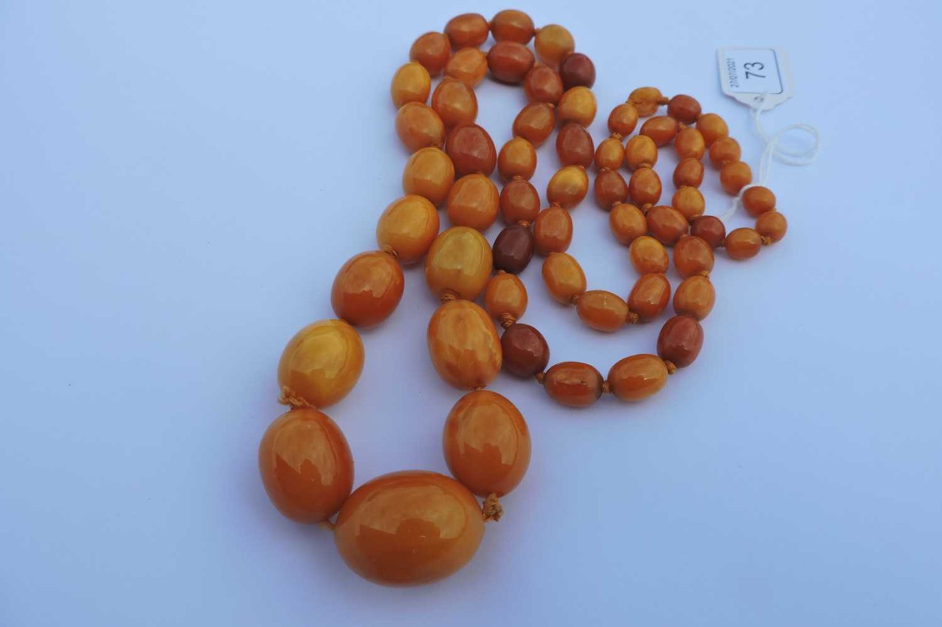 A single row graduated olive shaped amber bead necklace, - Image 2 of 4