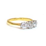 A gold three stone diamond ring,