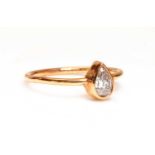 A rose gold single stone pear cut diamond ring,