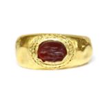 A Roman gentlemen's high carat gold cornelian intaglio ring,