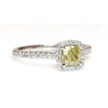 A platinum fancy yellow diamond and diamond halo cluster ring,