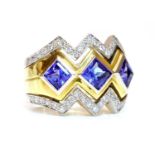 A gold three stone tanzanite and diamond ring,