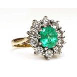 An 18ct gold emerald and diamond cluster ring,