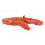 A late Victorian carved coral graduated snake bracelet, or semi flexible bangle,