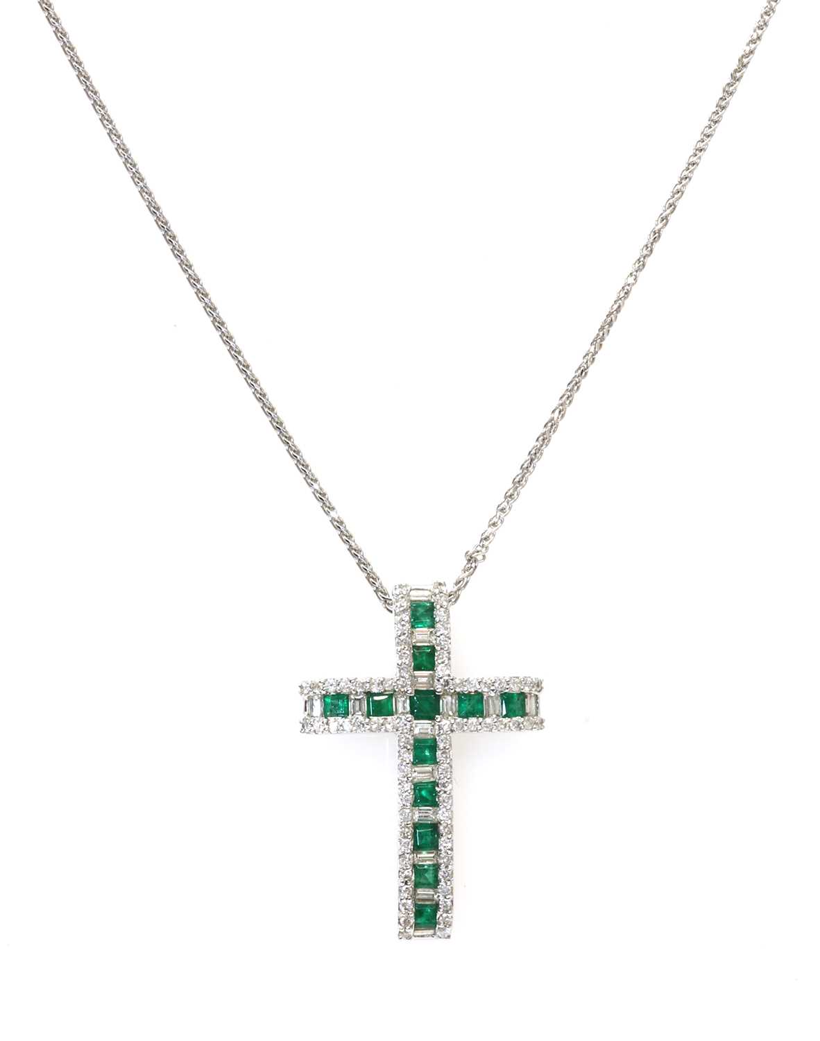 An 18ct white gold emerald and diamond Latin style cross,