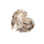 An unmounted fancy yellowish pink heart shaped brilliant cut diamond,