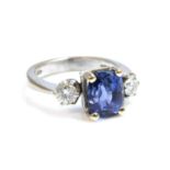 An 18ct white gold three stone sapphire and diamond ring,