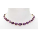 A late Victorian graduated amethyst rivière necklace,