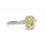 A platinum fancy yellow diamond and diamond halo cluster ring,
