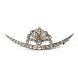 A late Victorian diamond set crescent and spray brooch, c.1890,