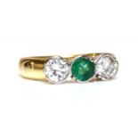 An 18ct gold emerald and diamond three stone ring,