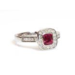 A platinum, ruby and diamond cushion shaped halo cluster ring,