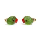 A pair of 18ct gold carved peridot and coral parrot head cufflinks, by Deakin & Francis, retailed by