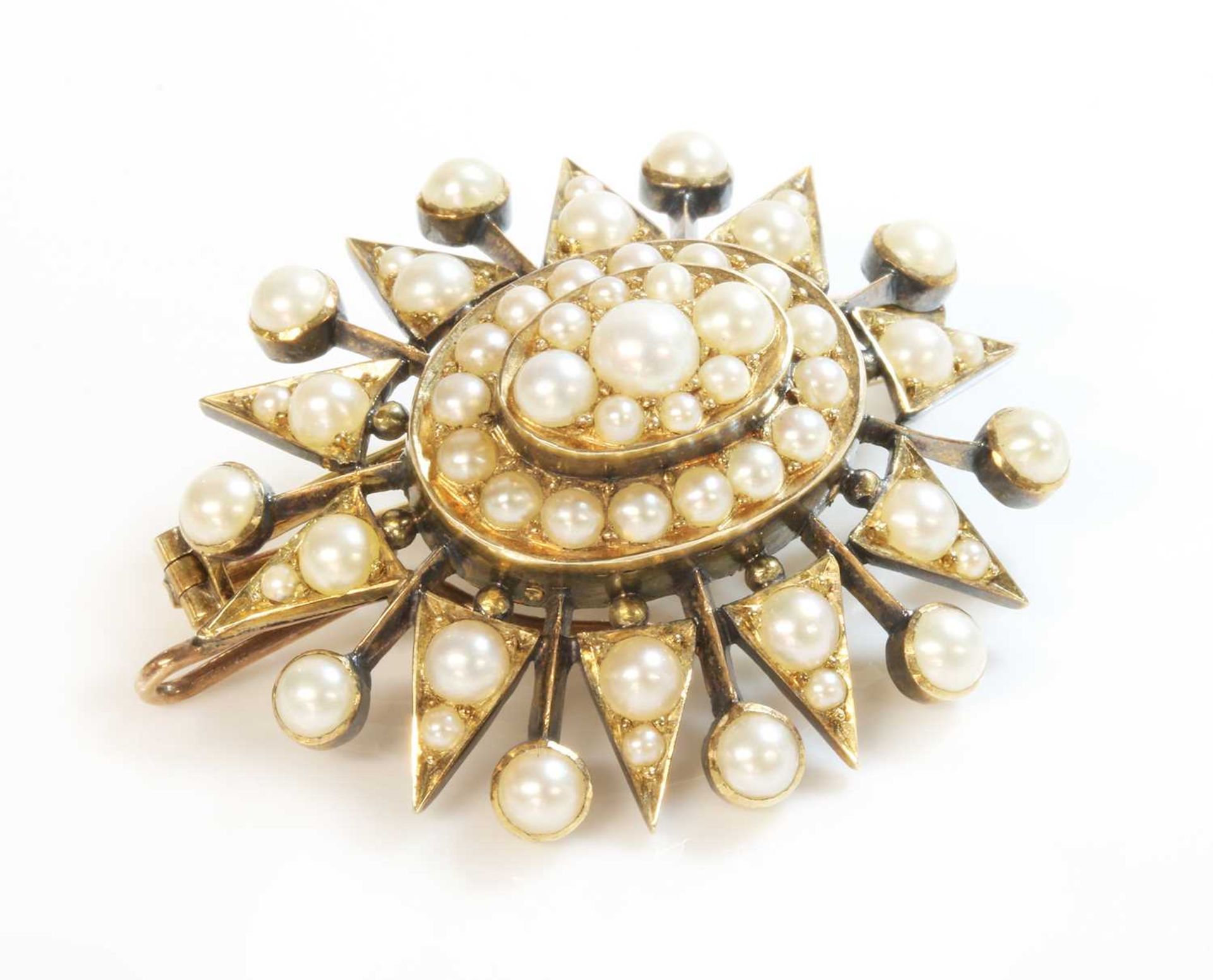 A Victorian gold split pearl oval starburst brooch/pendant, c.1900,