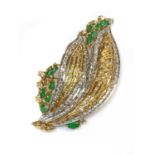 A two colour gold emerald and diamond spray brooch/pendant,