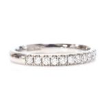 An 18ct white gold diamond set half eternity ring,