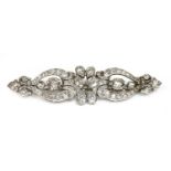 A diamond set bar brooch,