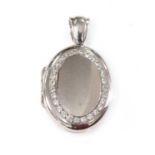 An 18ct white gold diamond set hinged locket, by Charles Green,