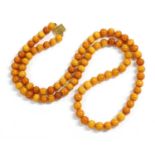 A single row uniform spherical butterscotch amber bead necklace,