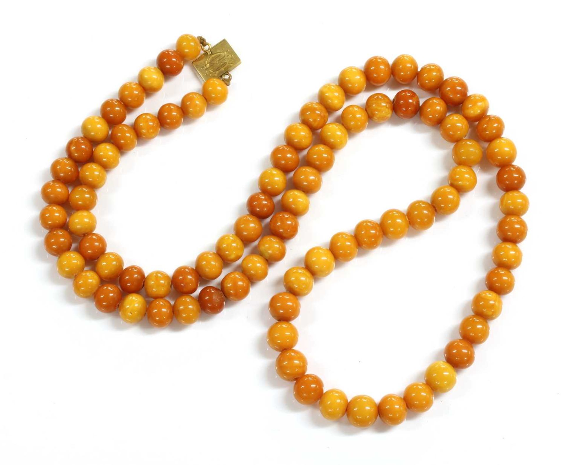 A single row uniform spherical butterscotch amber bead necklace,