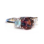 A white gold three stone colour change alexandrite and diamond ring,