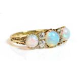 A Victorian seven stone opal and diamond carved head style ring,