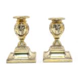 A pair of silver-gilt dwarf candlesticks,