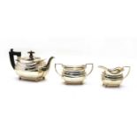 A silver three piece tea service,