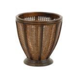 A mahogany and cane waste paper basket