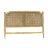 A French Louis XVI-style painted and caned headboard,