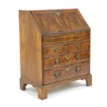 A George II feather strung and crossbanded walnut bureau