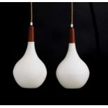 A pair of Scandinavian teak-mounted pendant lights,