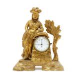 An 18th century carved pine and gilt figural mantel clock