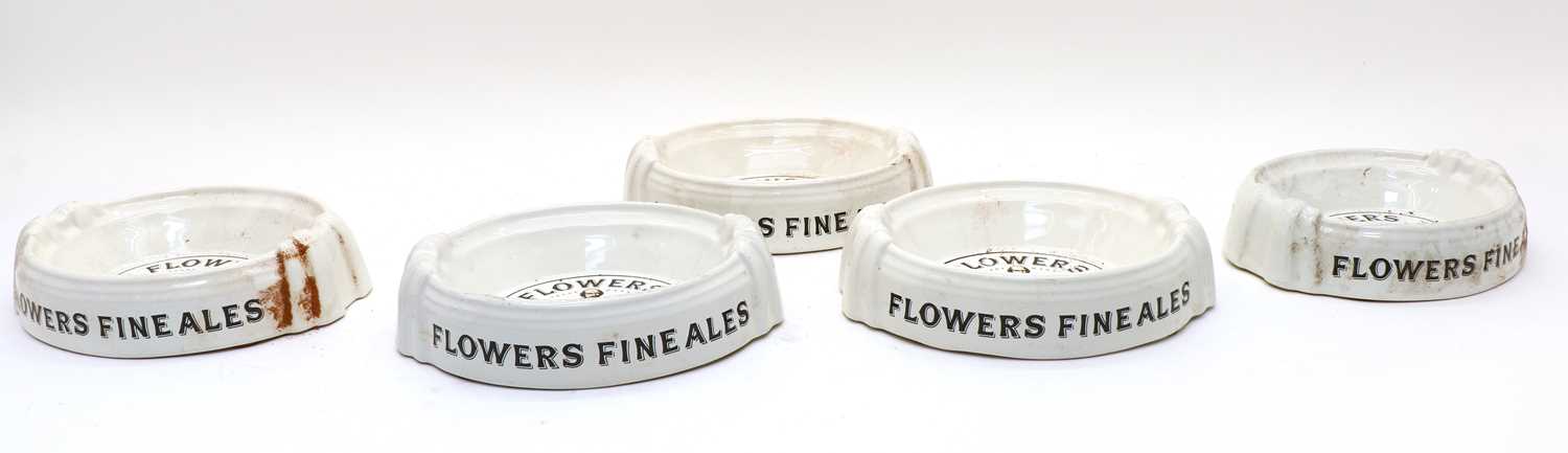 A collection of thirteen Flowers Fine Ales advertising ashtrays,