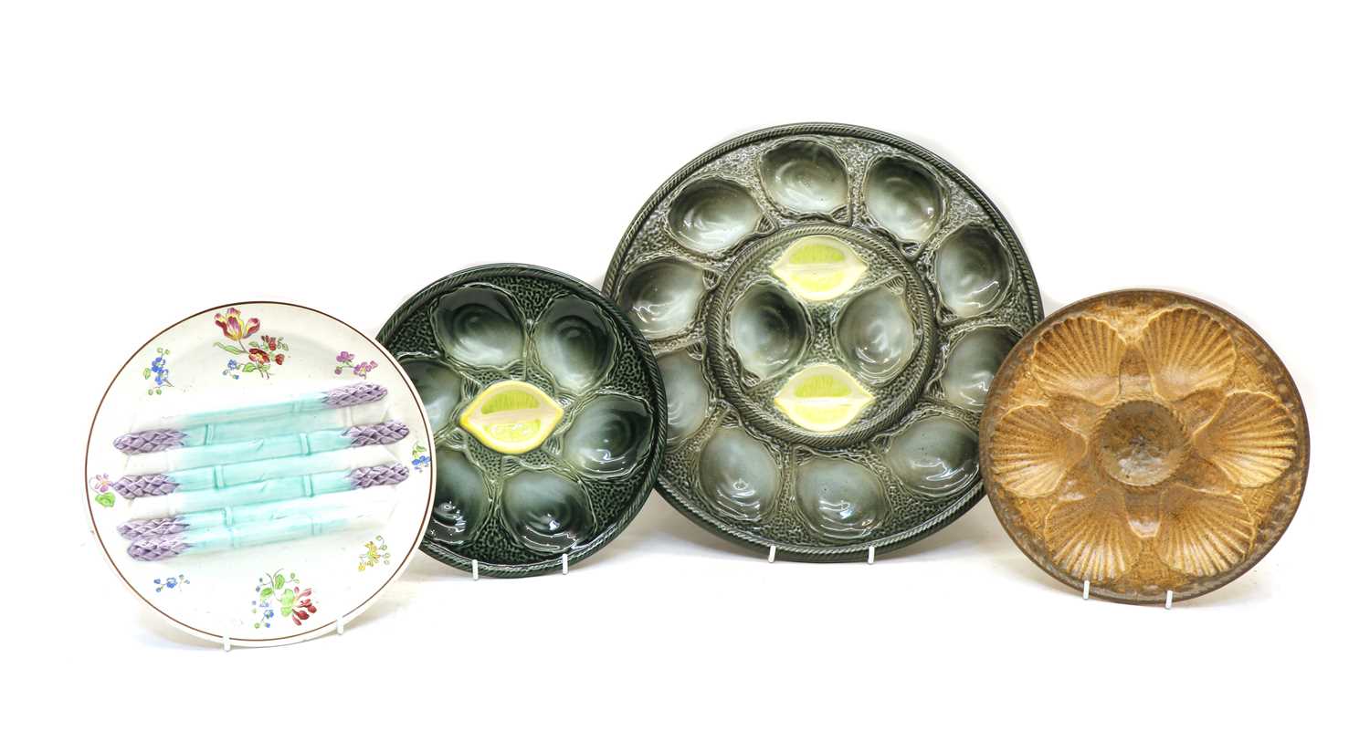 A group of various French faince and pottery oyster and asparagus plates,
