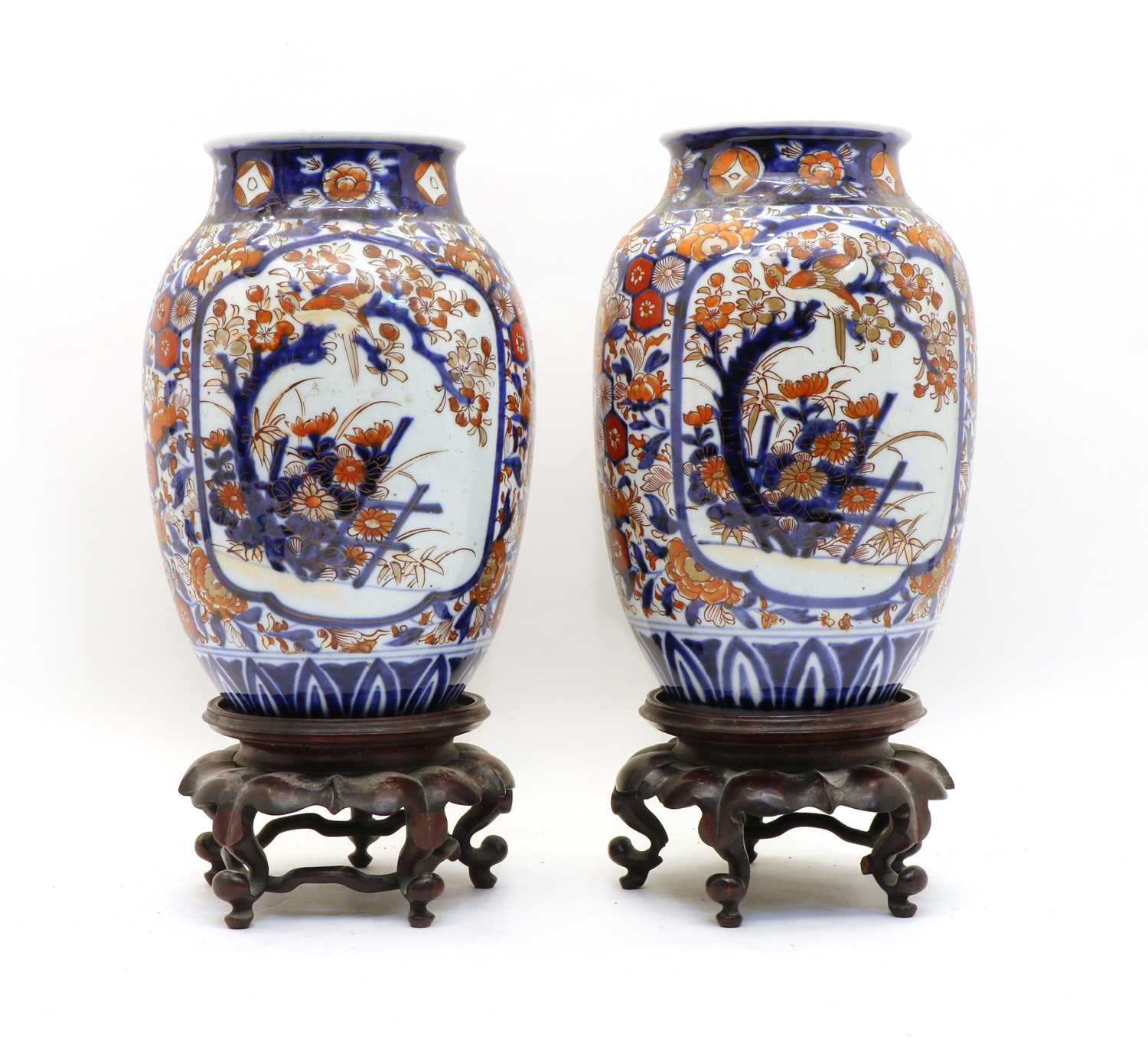 A pair of Japanese Imari vases on stands,