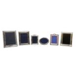 A collection of silver photograph frames,