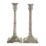 A pair of silver cluster column table candlesticks,