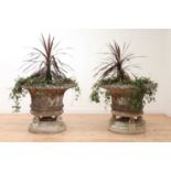 A pair of large composite stone garden planters,