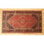 A Persian wool rug,