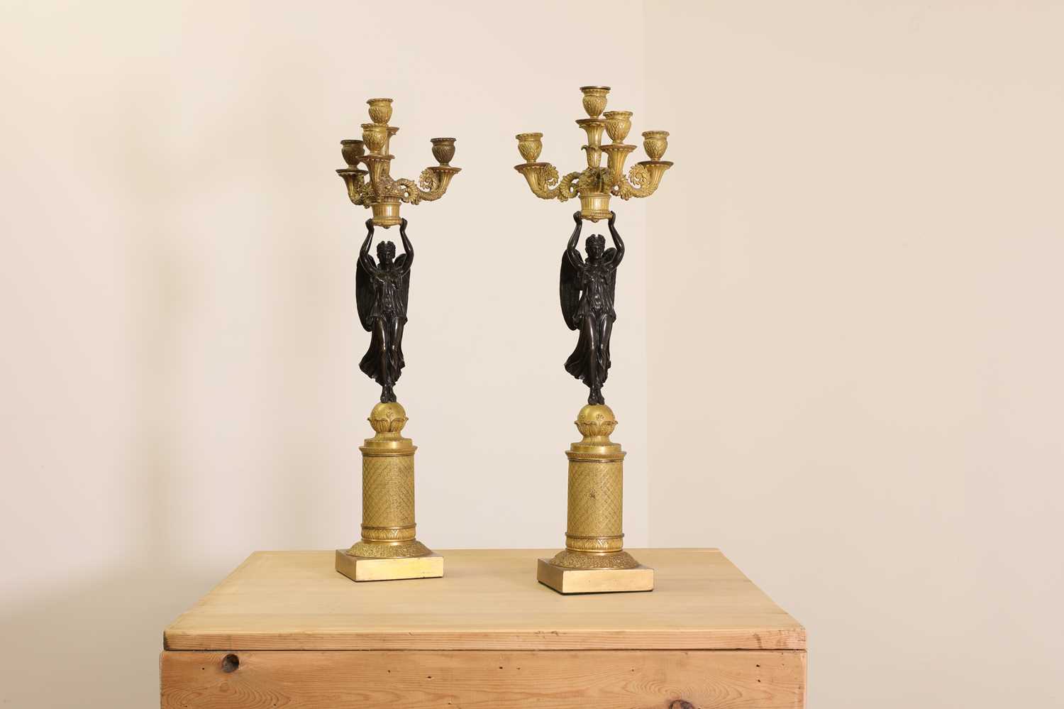 A pair of French Empire ormolu and bronze candelabra,