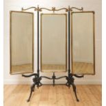 A cast iron and brass triptych cheval mirror,