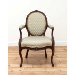 A carved beech open armchair,