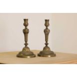 A pair of French bronze candlesticks,