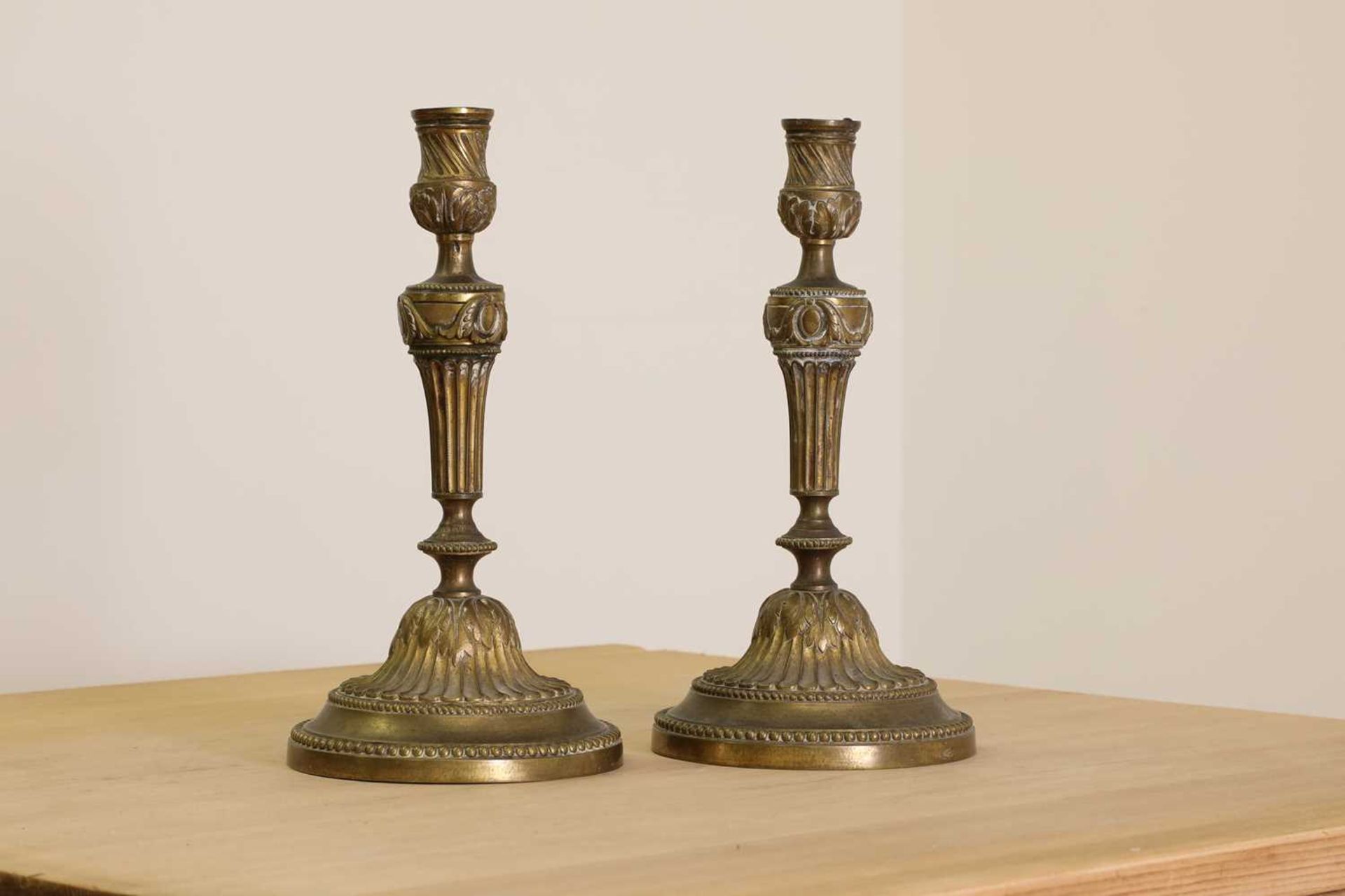 A pair of French bronze candlesticks,