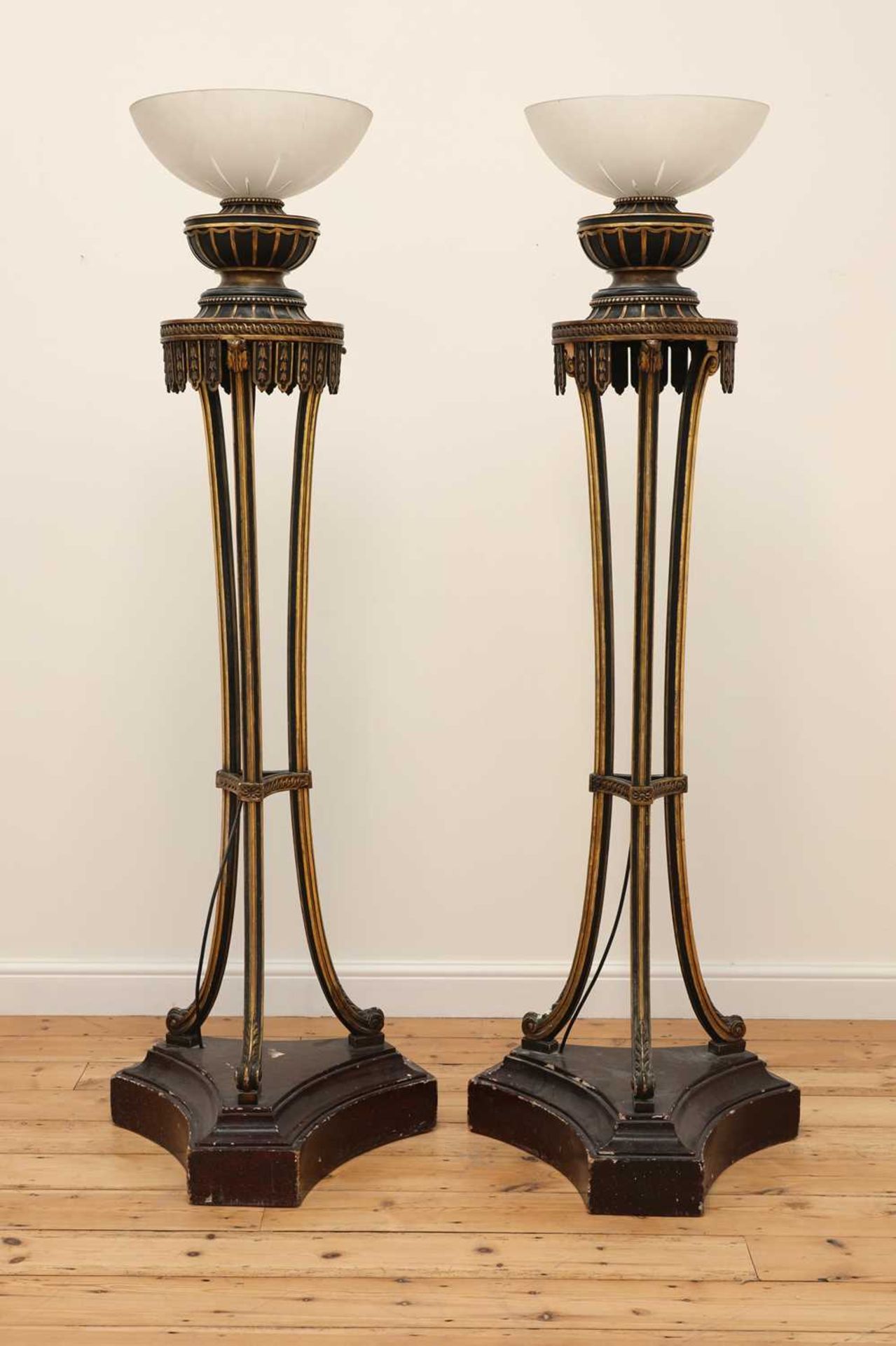 A pair of carved and painted torchères,