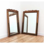 A pair of ebonised and parcel-gilt mirrors,