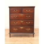 A narrow oak chest of drawers,